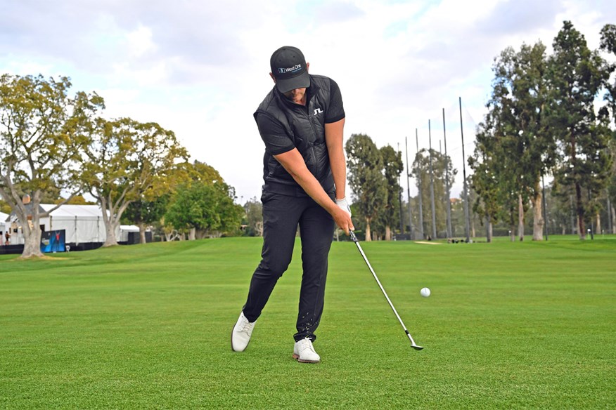 Matt Wallace practises hitting pitch shots with his right heel raised off the ground